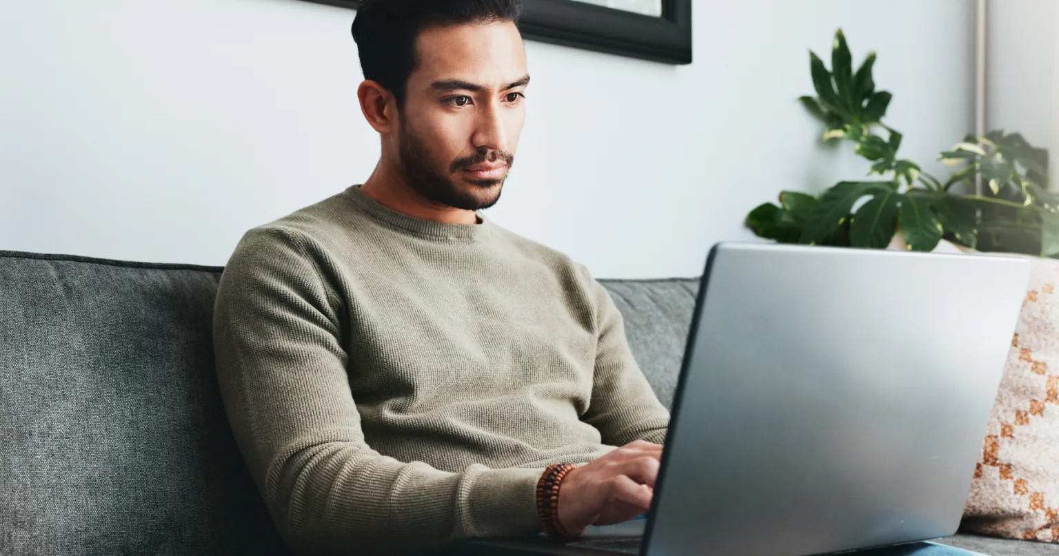 A small business owner checking what an AI assistant says about their company on a laptop