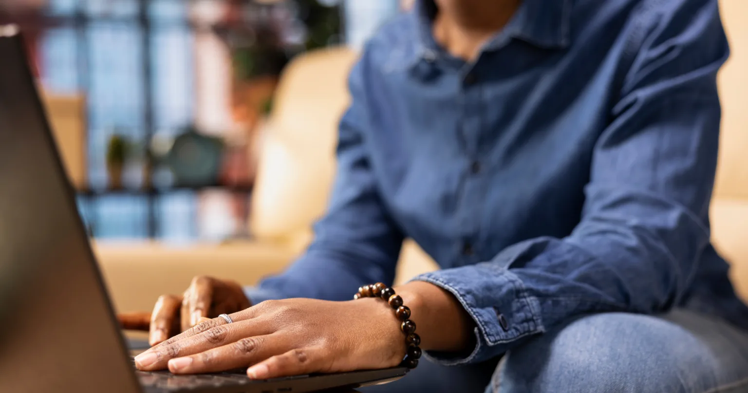 A warm, candid photo of a small business owner at their real workspace next to a glossy generic AI-generated image, showing the contrast between authentic and AI slop